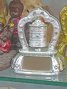 silver-colored Buddhist prayer wheel